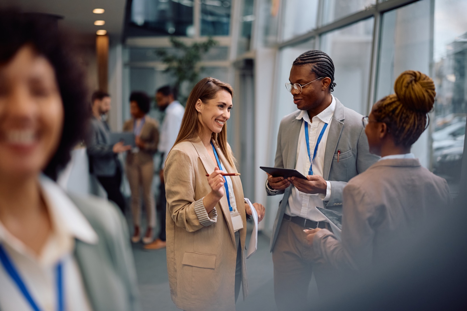 Profissionais em conversa de trabalho, um deles a tomar notas